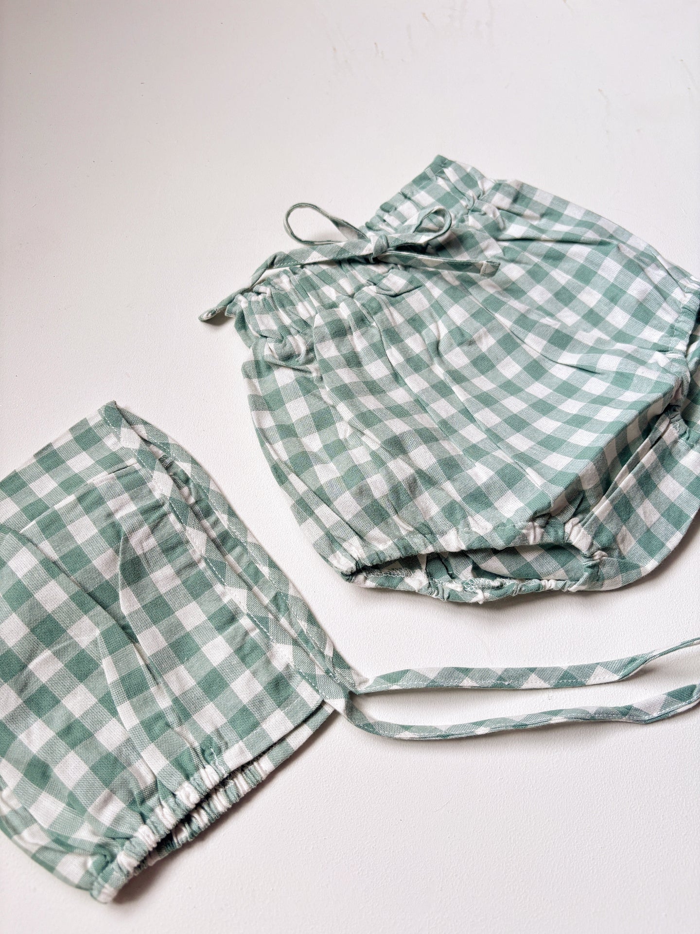 image shows a mint and cream organic cotton bonnet and bloomer set