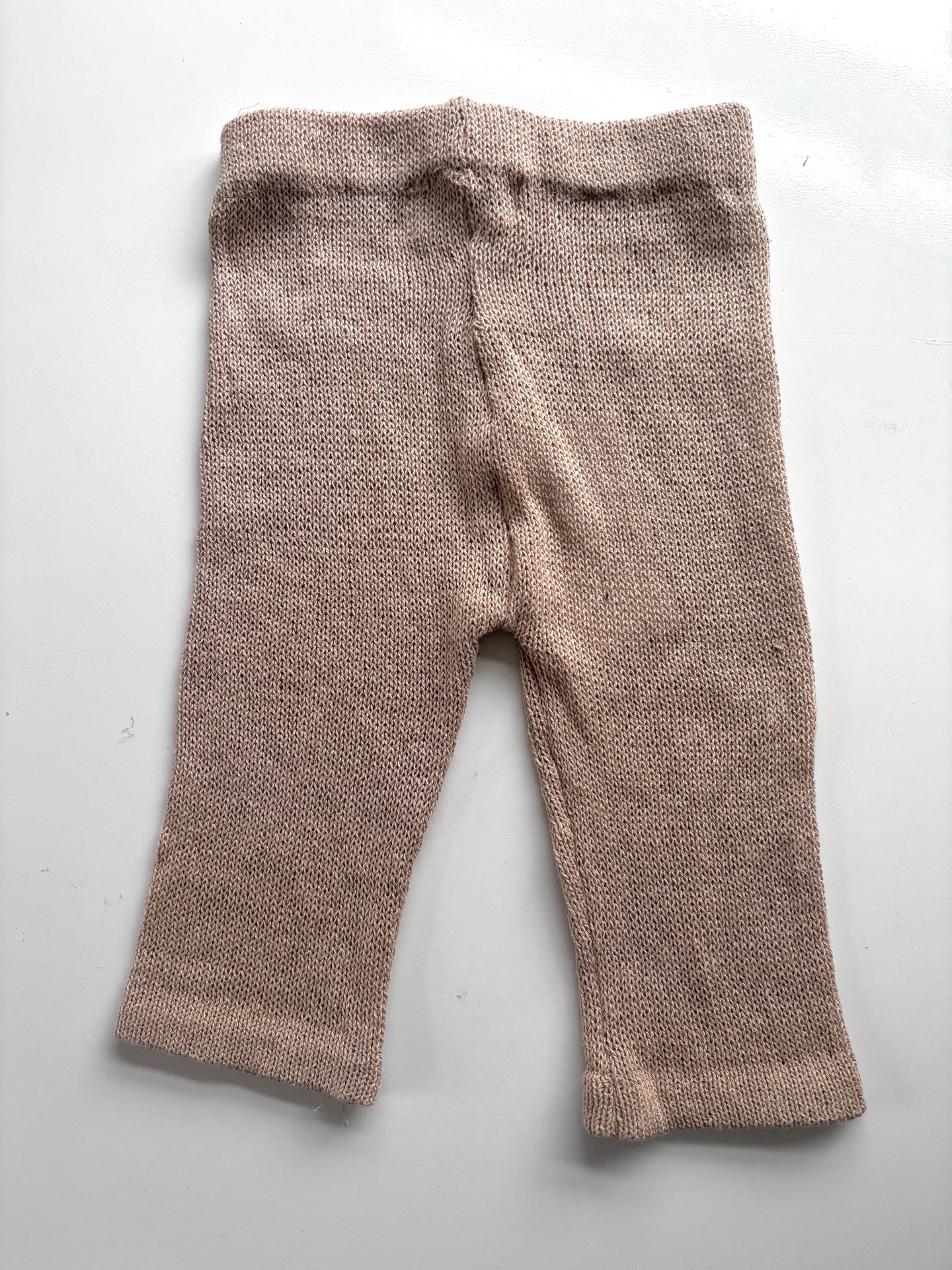 image shows neutral organic cotton baby trousers