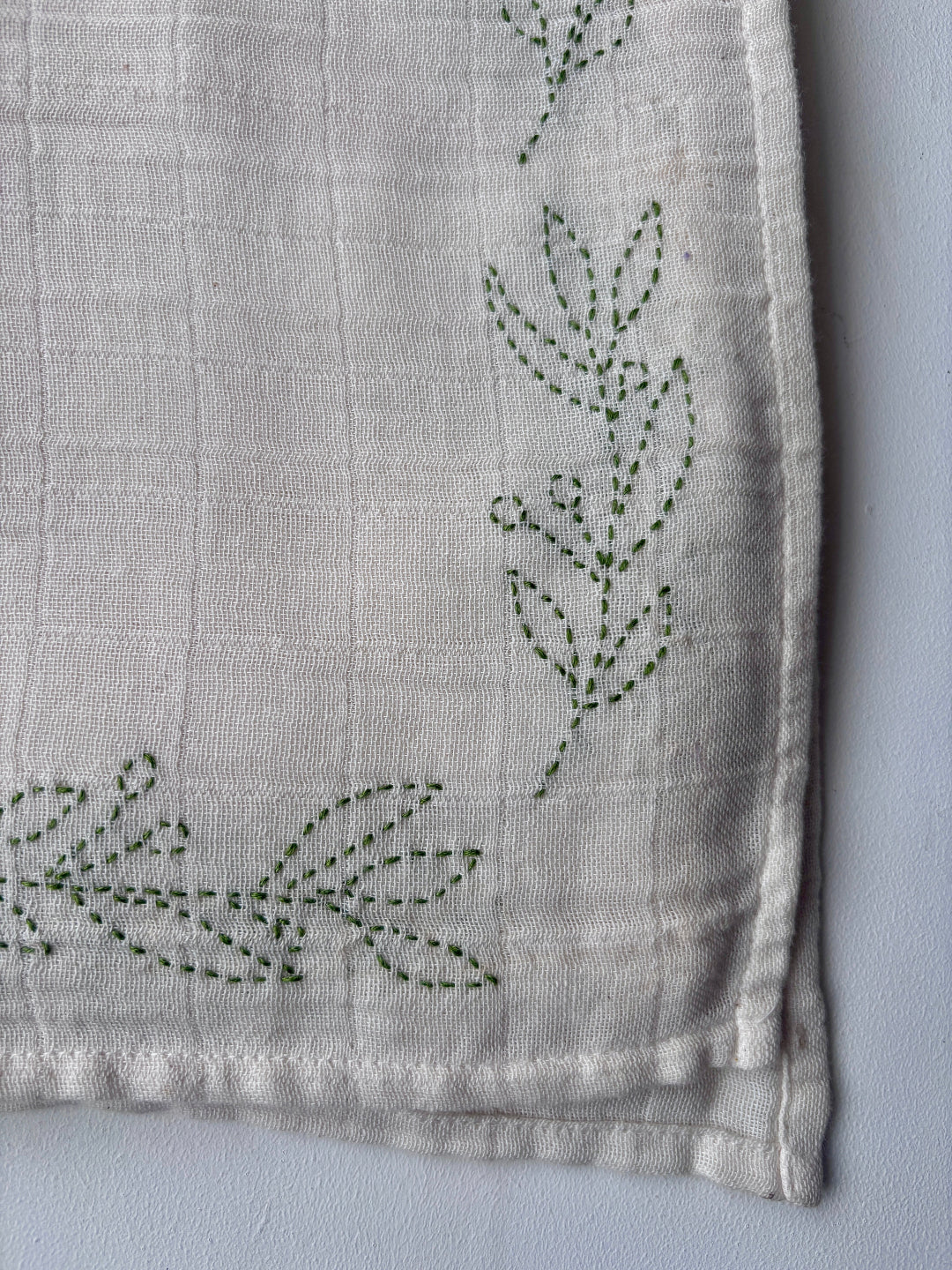 close up on olive sprig embroidery
