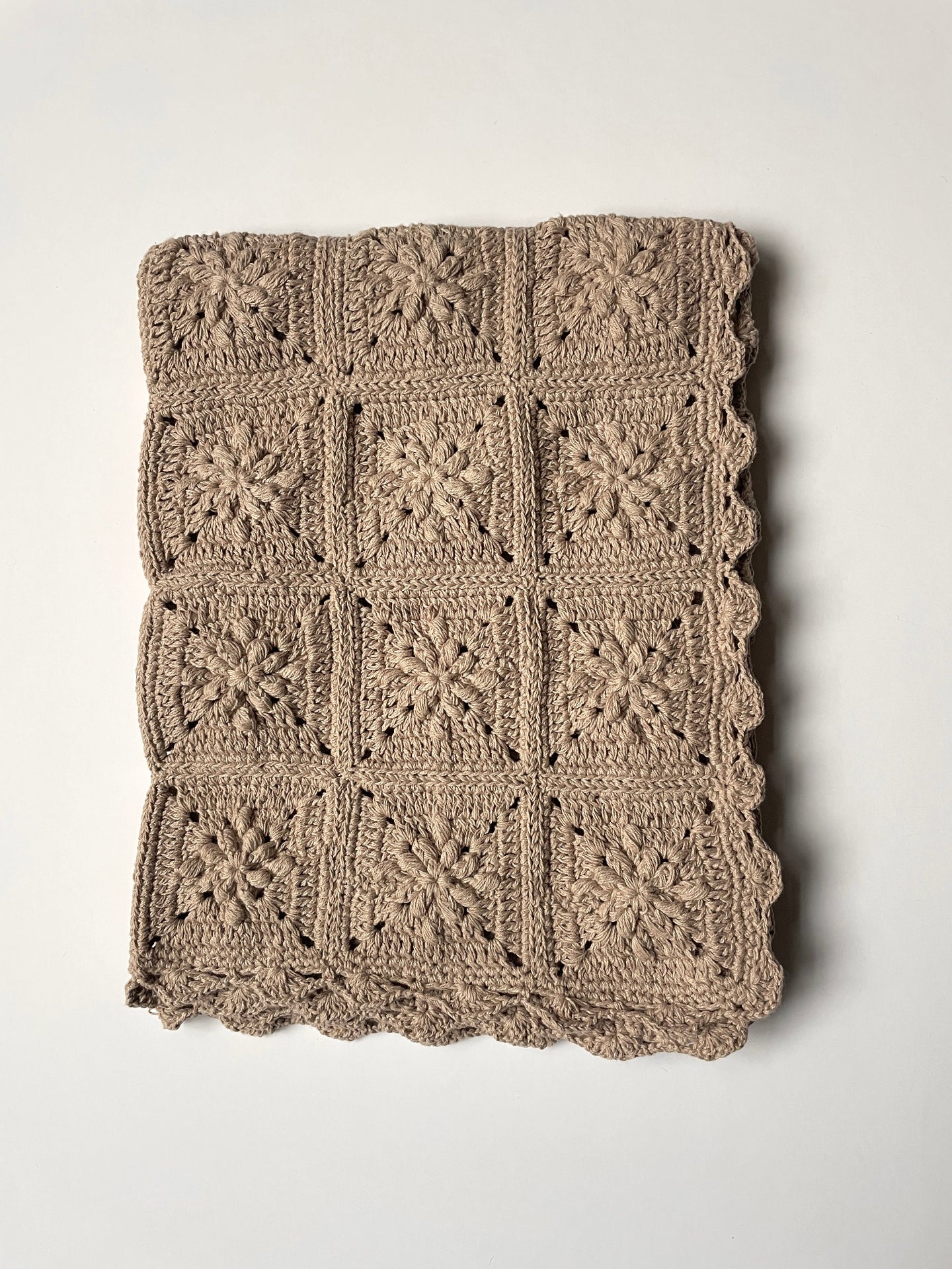 image shows sand light brown coloured organic cotton Nelly baby blanket