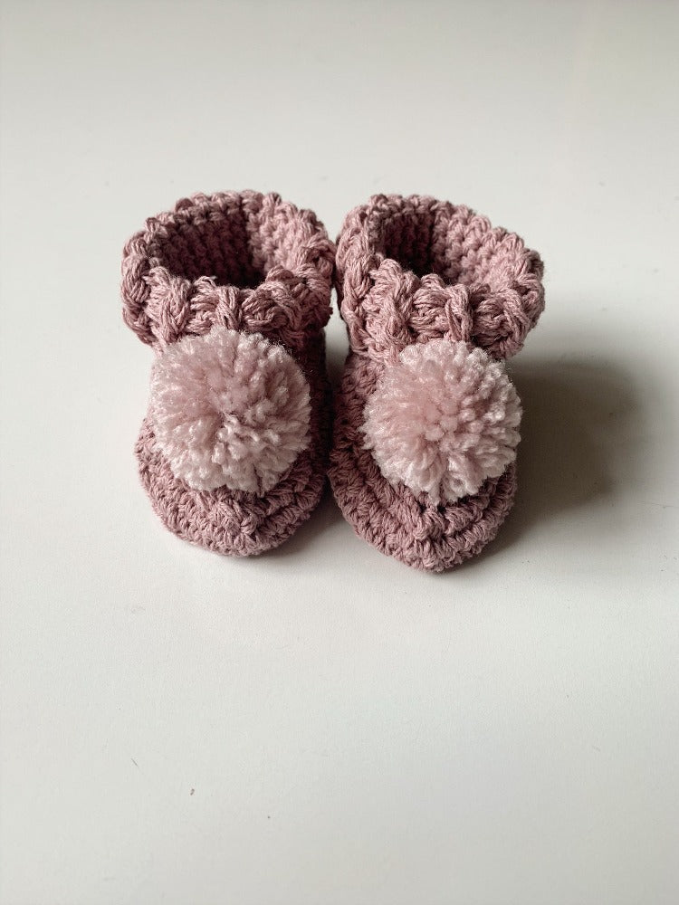 Image shows a pair of pink organic cotton baby booties